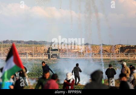 Gaza. 22nd Feb, 2019. Palestinians run to take cover from tear gas canisters fired by Israeli troops on the Gaza-Israel border, east of Gaza City, on Feb. 22, 2019. One Palestinian teenager was killed on Friday and dozens injured in clashes between hundreds of Palestinian protesters and Israeli soldiers during the weekly anti-Israeli rallies and protests held in eastern Gaza Strip, close to the border with Israel, medics said. Credit: Yasser Qudih/Xinhua/Alamy Live News Stock Photo