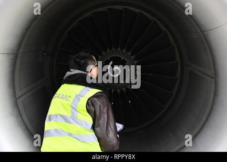 Lanzhou, China's Gansu Province. 22nd Feb, 2019. Technician Chen He examines the engine of an airplane in Lanzhou Zhongchuan International Airport, northwest China's Gansu Province, Feb. 22, 2019. During the Spring Festival travel rush, technicians from the maintenance division of Gansu Civil Aviation Airport Group Co., Ltd. face more checking and maintaining tasks due to a larger traffic flow. Credit: Chen Bin/Xinhua/Alamy Live News Stock Photo