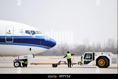 Lanzhou, China's Gansu Province. 22nd Feb, 2019. Technicians prepare an airplane for its take-off in Lanzhou Zhongchuan International Airport, northwest China's Gansu Province, Feb. 22, 2019. During the Spring Festival travel rush, technicians from the maintenance division of Gansu Civil Aviation Airport Group Co., Ltd. face more checking and maintaining tasks due to a larger traffic flow. Credit: Chen Bin/Xinhua/Alamy Live News Stock Photo