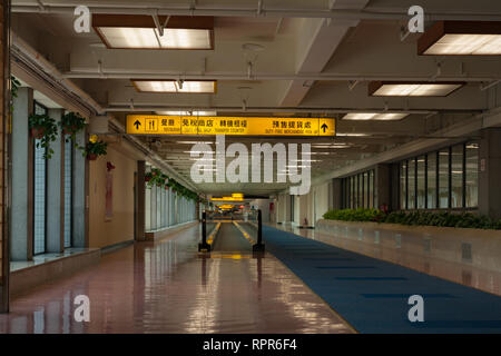 Restaurant, duty free shop, transfer counter signage; empty corridor and moving walkway in airport terminal, Taiwan Taoyuan International      Airport Stock Photo