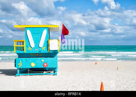 South Beach, Miami, Florida, lifeguard house in a colorful Art Deco style on cloudy blue sky and Atlantic Ocean in background, world famous travel location Stock Photo