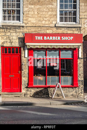 English village shop front, The Barber Shop in Market Place, Tickhill in the Metropolitan Borough of Doncaster in South Yorkshire, England, Stock Photo