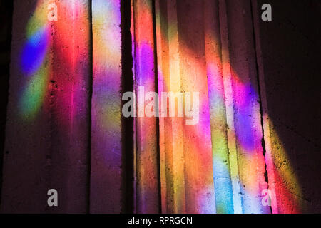 Colourful light reflections on a cement pillar Stock Photo