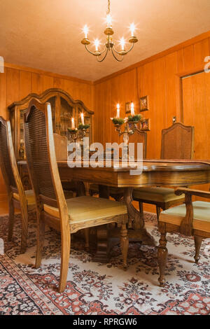 Table and grid high back chairs in the dining room inside an old circa 1834 home Stock Photo