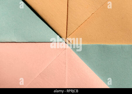 Abstract geometric paper shapes. Pastel tones crumpled paper. Hard light. Stock Photo