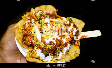 Indian famous Papdi Chaat (Papri Chaat). A yummy snack assorted with crunchy base of Papdi (crisp puris) topped with lip-smacking chutneys, veggies an Stock Photo