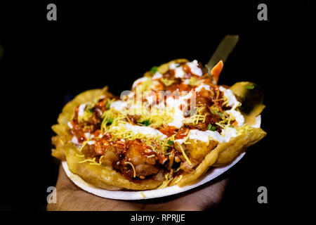 Indian famous Papdi Chaat (Papri Chaat). A yummy snack assorted with crunchy base of Papdi (crisp puris) topped with lip-smacking chutneys, veggies an Stock Photo