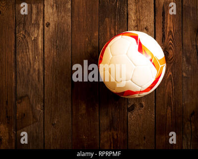 Soccer ball lying on the wooden table Stock Photo