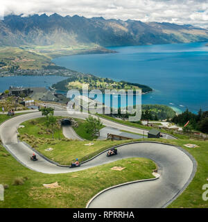 Luge track with mountains in the background at Queenstown Skyline site, New Zealand.