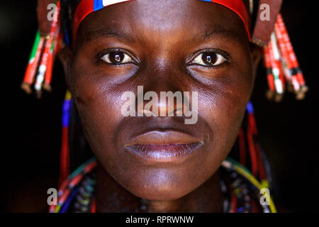 Portrait of a Hakaona (Zemba) woman with traditional ornaments and hairstyle. Namibia, Africa Stock Photo