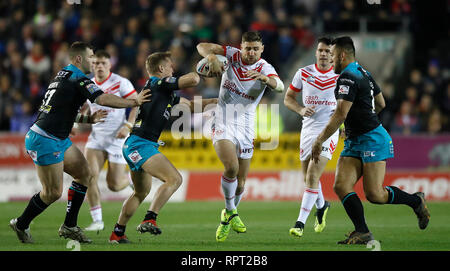 St Helens Saints' Tom Makinson is tackled by Leeds Rhinos Trent Merrin (left), Brad Dwyer (centre) and Nathaniel Peteru (right), during the Betfred Super League match at the Totally Wicked Stadium, St Helens. Stock Photo