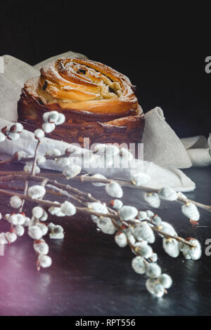 Easter cake kranch with icing sugar on a dark background and with willow flowers. Stock Photo