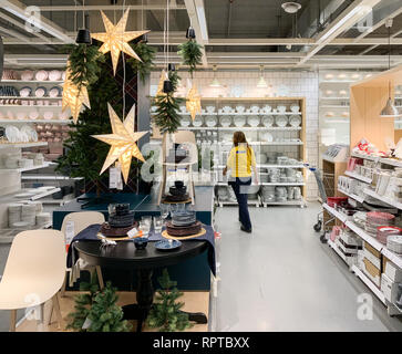 PARIS, FRANCE - COT 23, 2018: IKEA store getting ready for the Christmas and New Year holidays with special gifts and promotions selling holiday articles in the furniture warehouse store employee arranging Stock Photo