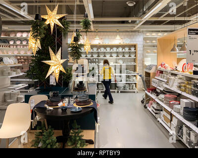 PARIS, FRANCE - COT 23, 2018: IKEA store getting ready for the Christmas and New Year holidays with special gifts and promotions selling holiday articles in the furniture warehouse store employee arranging Stock Photo