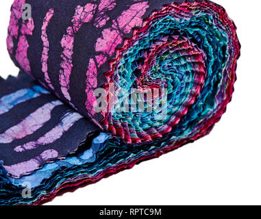 Multi-colored remnants of fabric rolled together to create a pattern Stock Photo