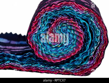 Multi-colored remnants of fabric rolled together to create a pattern isolated on white Stock Photo