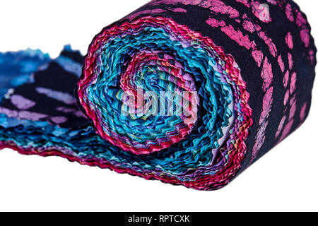 Multi-colored remnants of fabric rolled together to create a pattern Stock Photo