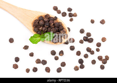 Black peppercorn in a wooden spoon isolated on white background. Top view Stock Photo