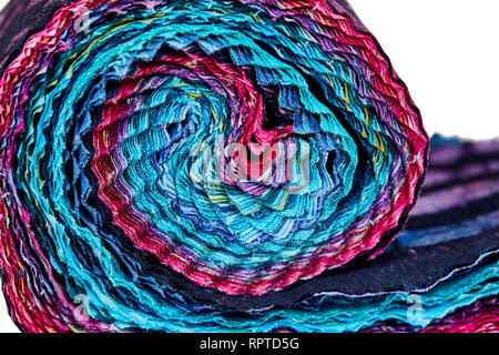 Multi-colored remnants of fabric rolled together to create a pattern Stock Photo