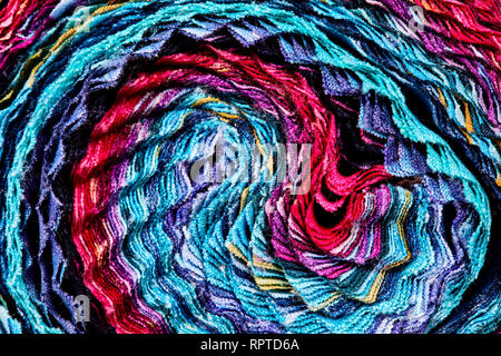 Multi-colored remnants of fabric rolled together to create a pattern Stock Photo