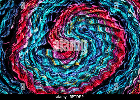 Multi-colored remnants of fabric rolled together to create a pattern Stock Photo
