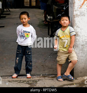 Two curious boys in ''their'' street in Shanghai, China. Stock Photo