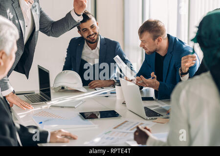 startup business, creative multiethnic business people of different age and races gather in meeting room in white modern office interior, vivously dis Stock Photo