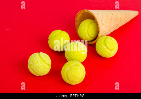 Waffle cone with yellow rubber bands on bright background. Studio Photo Stock Photo