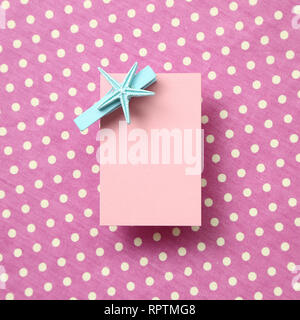 Pink memo pad, sticky note on pink dot pattern fabric background Stock Photo