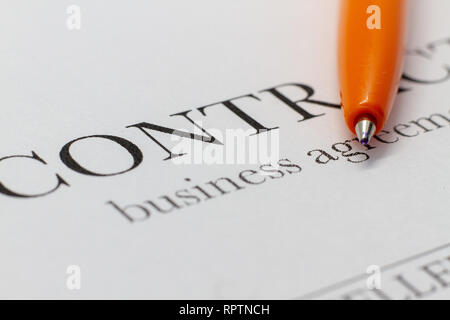 Fragment of a contract printed on paper with a ballpoint pen. Macrophoto Word Contract Closeup. The buyer and the seller made a contract on paper. Stock Photo
