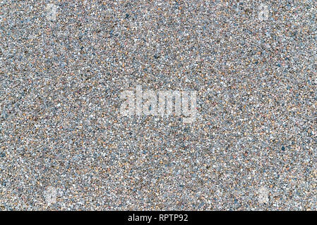 White granite gravel stones flooring pattern surface texture. Close-up of exterior natural material for design decoration background. Stock Photo