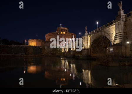 beautiful view of Castel Sant'Angelo and the bridge at night with reflections on the Tiber river. Rome Italy Stock Photo