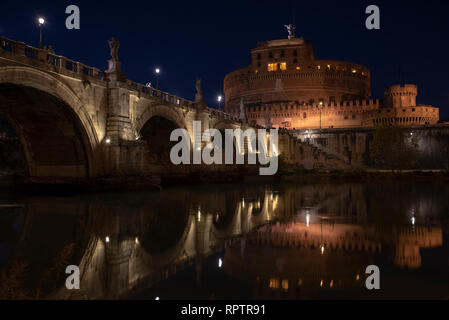 beautiful view of Castel Sant'Angelo and the bridge at night with reflections on the Tiber river. Rome Italy Stock Photo