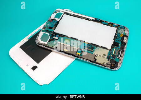 Close-up photos of disassembled mobile phone tablet. Tablet repair spare parts. Stock Photo