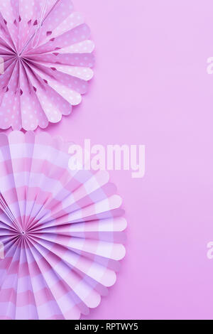 Chinese paper fans in pastel colors on lilac table, top view, copy space for text, selective focus Stock Photo