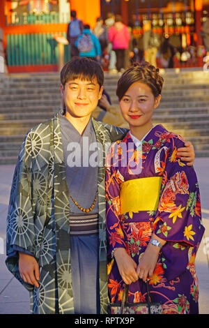 Young Japanese couple in traditional clothing with woman wearing kimono in Kyoto. Stock Photo