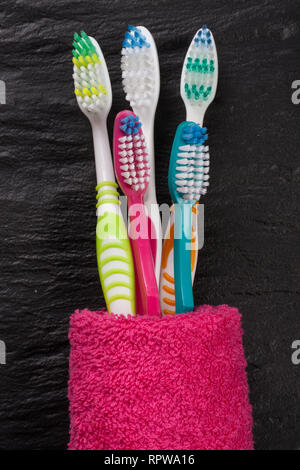 toothbrushes on the black stone background Stock Photo