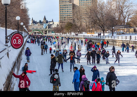 People celebrate the Winterlude festival on the frozen Rideau Canal, the world’s largest outdoor skating rink with 7km in Ottawa, Canada capital Stock Photo