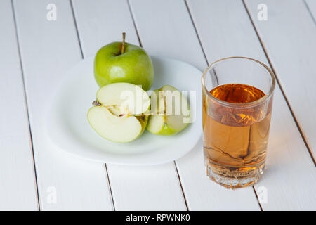 apple juice pouring from green apples fruits into a glass Stock Photo