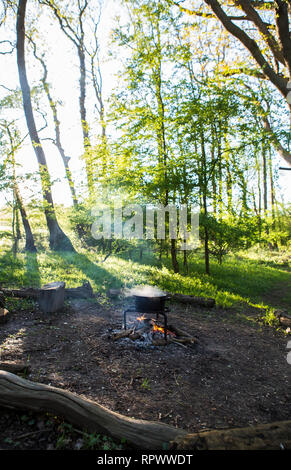 Cooking over a campfire in a woodland in Kent, UK Stock Photo