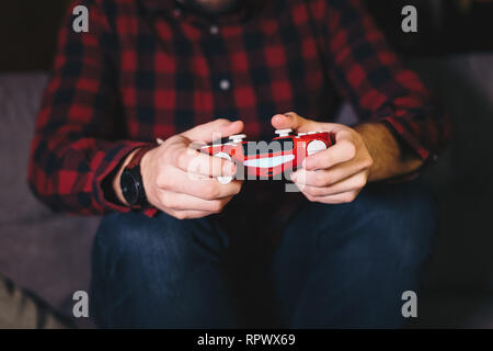 Detail shot of man's hands using a video game controller. Stock Photo