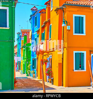 Street with vivid colored houses in Burano Island, Venice, Italy Stock Photo