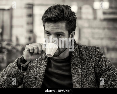 Attractive Man Drinking Coffee in a Bar Stock Photo