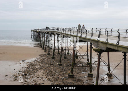 People enjoying a stroll along the historic pier at Saltburn-by-the-sea, North Yorkshire, England. Stock Photo