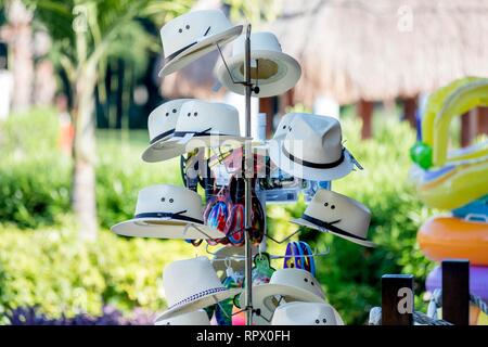 Souvenir vintage Panama hats hung on a stand outside a shop in a beach resort in the caribbean area of the Riviera Maya in Mexico. Stock Photo