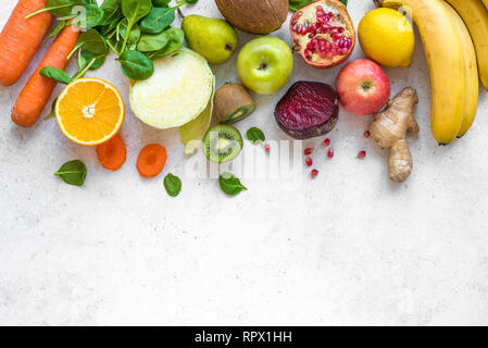 Colorful fruits and vegetables on a white table. Juice and smoothie ingredients. Healthy clean eating, detox, diet concept. Stock Photo