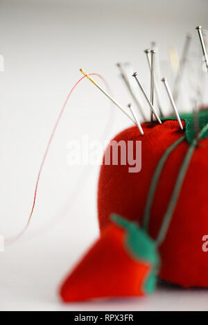 Pins and sewing needles in a pin cushion Stock Photo