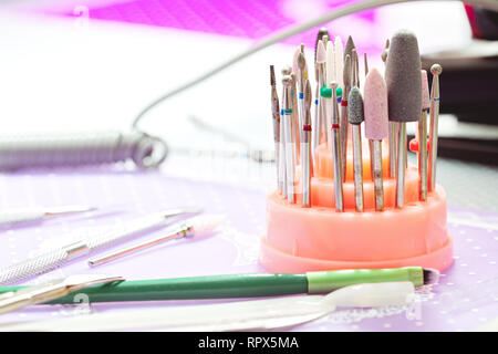 A set of cutters for the device for manicure and tools for nail care on the table Stock Photo