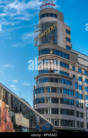 Madrid, Spain - February 20, 2018: Bus windows reflections and Iconic edificio Carrion building. Located in Gran Via and Jacometrezo street junction,  Stock Photo
