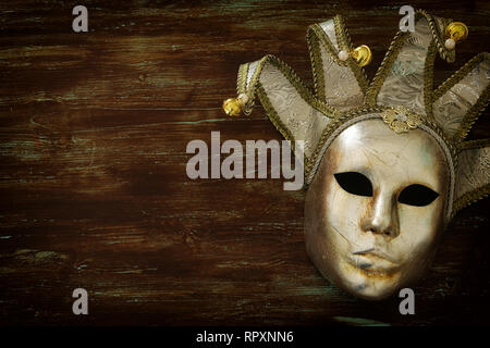 Masquerade decorations on dark wooden background Stock Photo by